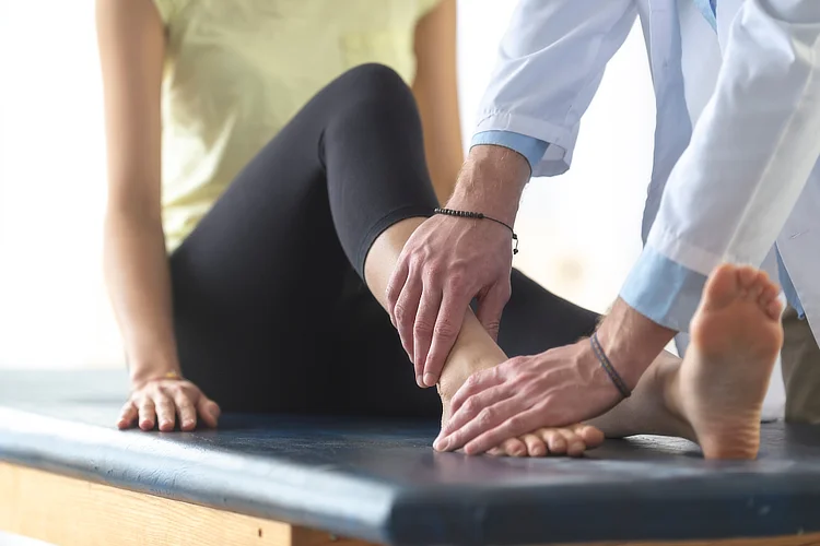 Ankle specialist assessing patient with Achilles tendonitis.