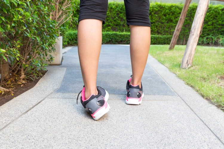 Foot misstepping outward on garden path illustrating how sudden twists can cause an ankle sprain.