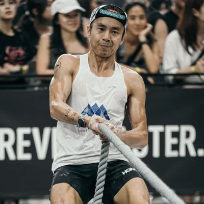 Dr. Foo Gen Lin competing in HYROX rope pull station showing intensity and risk of fatigue injuries.