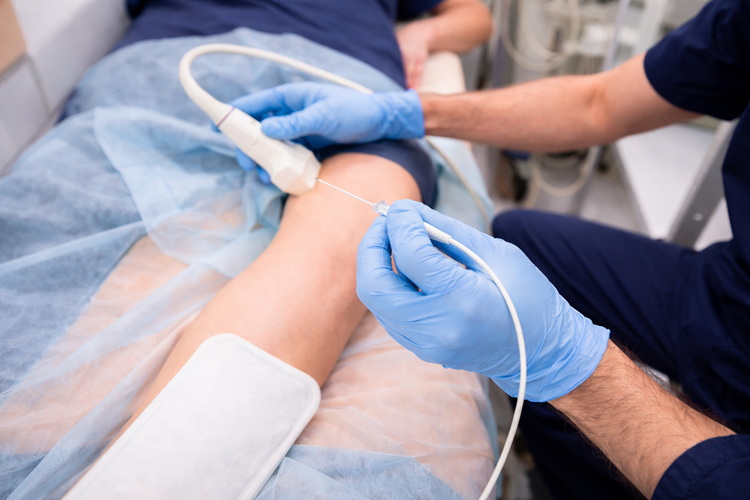 Orthopaedic specialist performing radiofrequency ablation on a patient’s knee.
