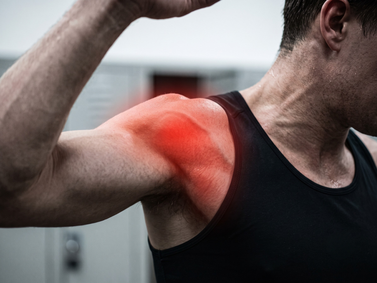 Man raising his arm overhead with pain highlighted at the front of the shoulder.