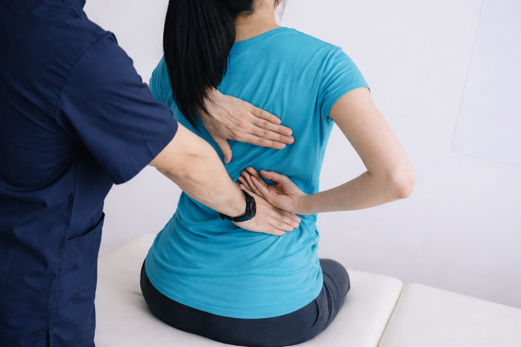 Physiotherapist assessing patient during rehabilitation after epidural injection.