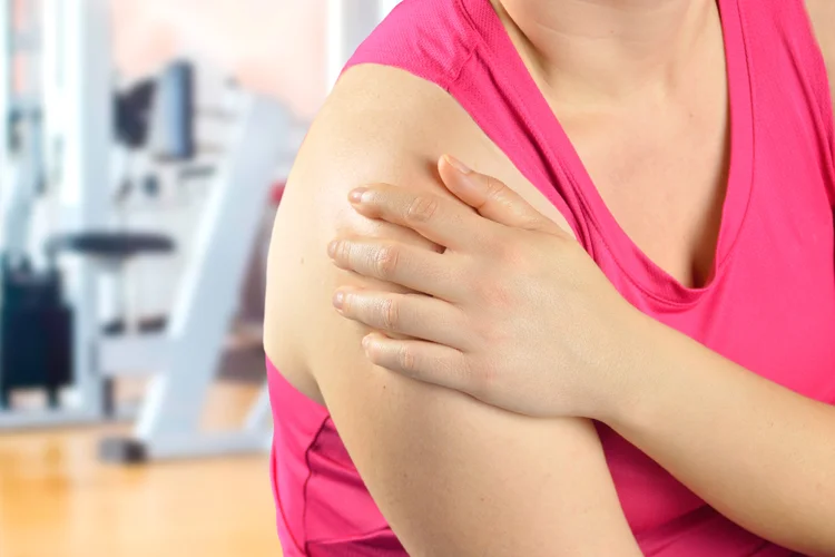 Woman experiencing post-traumatic shoulder arthritis with pain and stiffness.