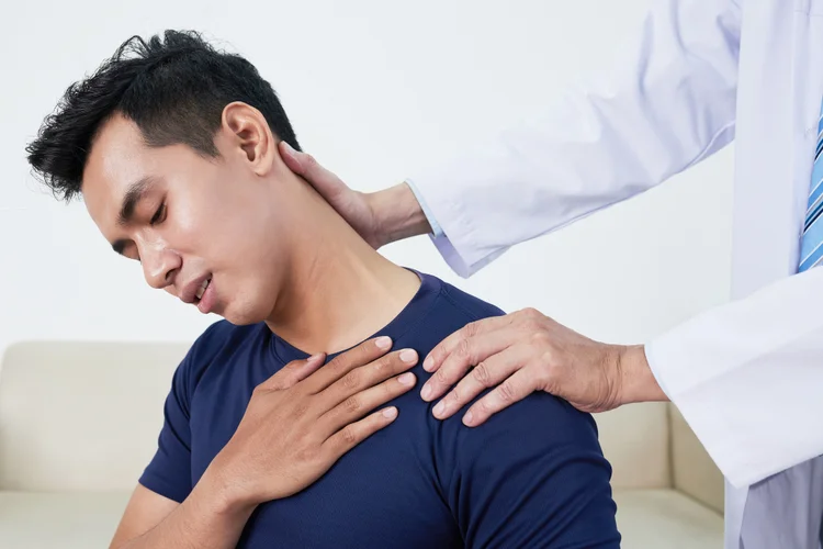 Shoulder specialist assessing mobility, strength, and tenderness.